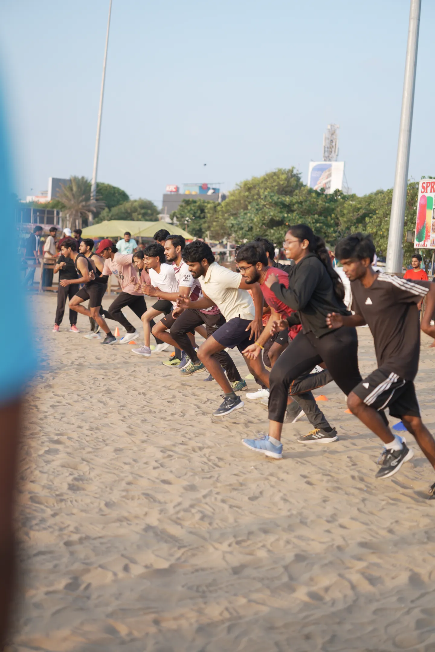 Participants of every pace sprinting off the start line together on the sand